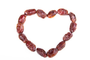 Dried fruits, dates, apricots, prunes in the form of heart on li